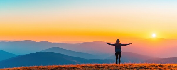 A person enjoying a sunset view over mountain landscapes.