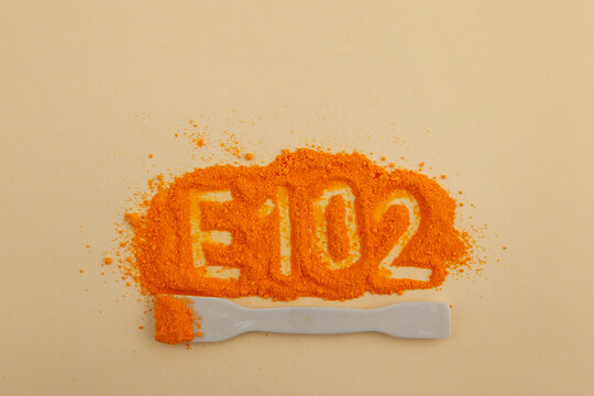 Food additive E102. Tartrazine powder. Food coloring, pigment. Tartrazine is a synthetic lemon yellow azo dye. CI 19140 or FD&C