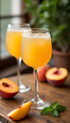 Fototapeta premium Table arrangement with Peach Bellini, peach slices and a sprig of mint, with a cozy cafe background