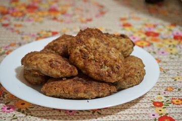 a plate of meat cutlets, baked homemade patties made of minced meat, with a golden crust