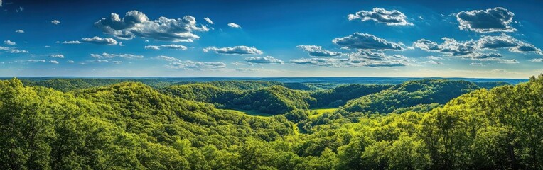Obraz premium A breathtaking panoramic view of rolling hills and lush green valleys under a bright blue sky in the serene countryside