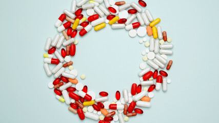 Concept of medicine, healthcare, and pharmaceutical industry. Various colorful pills and capsules scattered