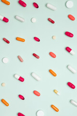 Concept of medicine, healthcare, pharmaceutical industry. Various colorful pills and capsules scattered