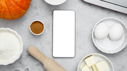 Ingredients for baking cookies for Halloween, smartphone mock-up. Seasonal autumn baking