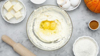 Seasonal autumn baking. Ingredients for baking Halloween cookies including flour, butter, sugar, spices, eggs and pumpkin