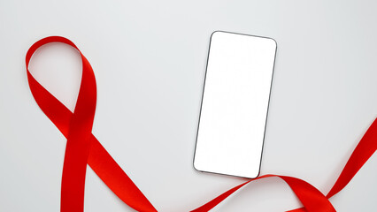World AIDS Day. Red ribbon with AIDS awareness and a smartphone for mock up
