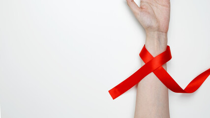World AIDS Day. Woman holding red AIDS awareness ribbon