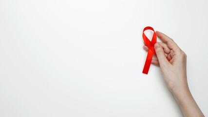 World AIDS Day. Woman holding red AIDS awareness ribbon