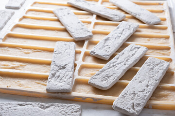 Finished decorative brick and silicone mold for pouring construction gypsum. Closeup.