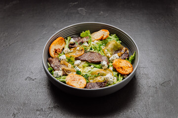 Gourmet salad with blue cheese, pear slices, toasted bread, and greens, perfect fusion of flavors