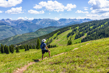 Vail summer in ski resort with hiking trail in Colorado with mountain peaks and mount of the holy cross in wilderness
