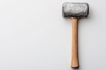 A steel hammer with a wooden handle on a light background.