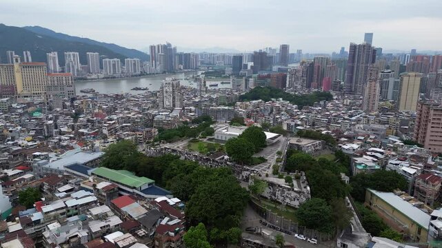 Macau, China: Aerial drone footage of the ancient Monte Fort citadel toward the ruin of the St Paul cathedral in the heart of Macau colonial old town in China. 