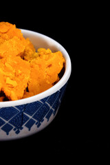 The Gujarati Kathiyawadi Spicy Dhokali Sabji is showcased in a portrait format, beautifully positioned in a bowl, complemented by a bold black background that emphasizes its features