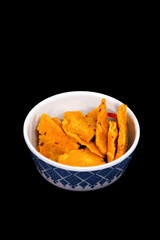 Top view of Gujarati Kathiyawadi Spicy Dhokali Sabji in a bowl, complemented by a bold black background that emphasizes its features