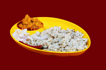 Left Side view of Gujarati Kathiyawadi Spicy Dhokali Sabji with khichdi, on yellow dish prominently, set against a black background