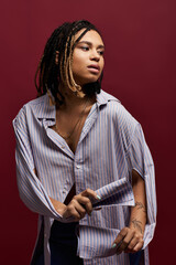 A fashionable young woman with braided hair showcases her style against a bold backdrop, exuding confidence and flair.