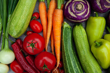 Top view of fresh vegetables - carrots, peppers, zucchini, tomatoes, onions and kohlrabi cabbage - for health and cooking, wellness and nutrition. Vegetables, organic produce and cuisine with dinner