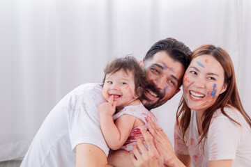 Multicultural parent with little toddler having fun laugh playing spending free time painting faces in holiday love bonding, Have fun and take photos together, learning skills of preschool children.