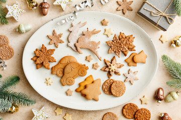Homemade Christmas cookies and the traditional gingerbread on a plate with Festive Decorations. Top view.