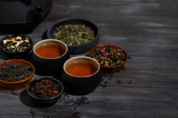 tea assortment. black, floral and herbal drinks on wooden background, top view