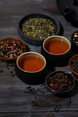 tea assortment. black, floral and herbal drinks on wooden background, vertical top view