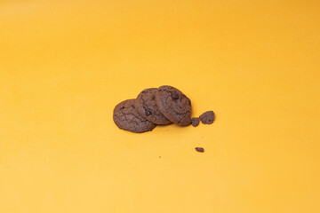 stack of cookies with chocolate chips on yellow background