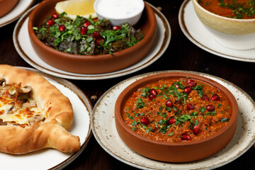 Assorted traditional Georgian cuisine on a black wooden table