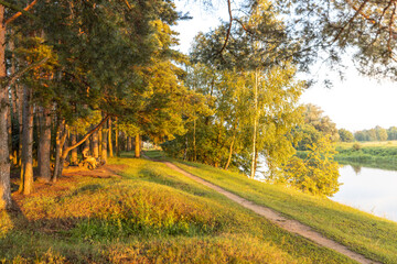 Path runs along a river with trees on either side