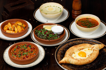 Assorted traditional Georgian cuisine on a black wooden table