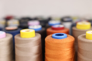Many different spools of thread in professional workshop, closeup