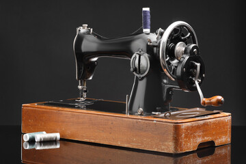 Vintage professional sewing machine on black background