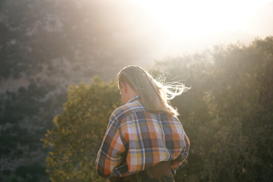 a young man with long blond hair glowing in the sun. Healthy long hair for a man