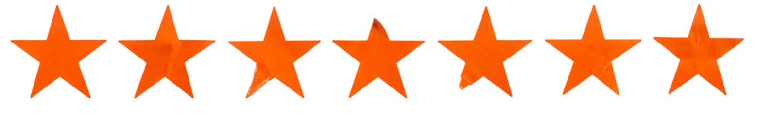 Obraz premium A set of orange star shape paper sticker label isolated on white background.