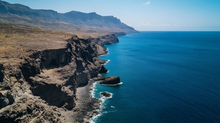 Fototapeta premium High perspective of a rocky coastline with cliffs meeting the ocean in a balanced, dramatic landscape with a perfect division between land and sea. No text, no logo, wide angle shot, cinematic scene,