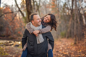 Couple Embracing on Park Bench. lovely couple kissing outdoors in autumn