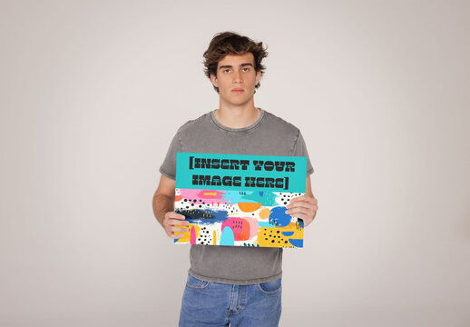 Man Holding a customisable poster. PSD mockup template