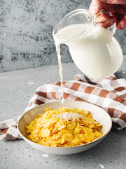 Crispy Corn Flakes with Milk Splash, Healthy Breakfast Cereal in Bowl, Morning Energy Meal