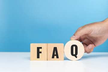 FAQ, frequently, asked, questions, topic. Wooden cubes with the word FAQ at the table in the office