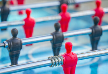 Table football soccer game kicker . Table football game, Soccer table with red and black players