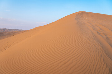 The vibrant sun is slowly setting over a vast desert landscape, Kashan, Iran