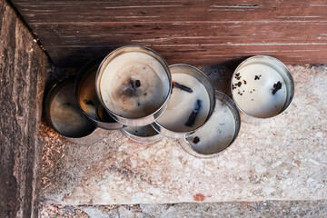 Trevi, Italy - 11 02 2024 - Old candles used for a procession piled at the side of a door in a small Umbrian village