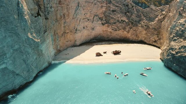 The world famous Zakynthian beach of Navajo hidden in a beautiful bay shaped by rocks and showing white sand, turquoise clear water and its landmark, the shipwreck.