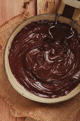 a bowl of chocolate dough , a whisk for a mixer, baking, structure and consistency, homemade, top view, no people,