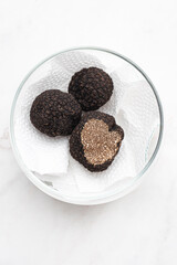 Black truffle, how to keep the black truffle mushroom fresh, in an airtight jar, in paper. Preserving black truffle. Delicacy condiment for flavoring dishes, top view