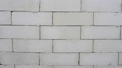 Fototapeta premium White Hebel Brickwall. Made from a mixture of Silica Sand, Gypsum, Limestone, Cement, Water and Powdered Aluminium. Background for Text or Image. Clipping Path for your Design. 