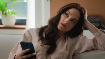 Caucasian woman scrolling mobile phone browsing smartphone receive negative answer disappointed female chat app on cellphone girl indoors at home businesswoman in office feel sad annoyed upset failure