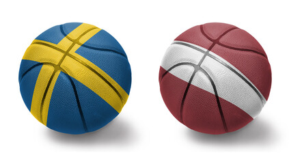 Obraz premium basketball balls with the national flags of latvia and sweden on the white background.