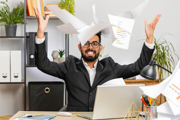 Stressed Indian businessman working looking at unpaid bank debt bills, doing paperwork, planning...