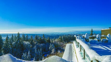 Snowbound rooftop patio overlooking spectacular Fraser Valley, BC, Canada winter scenery.
